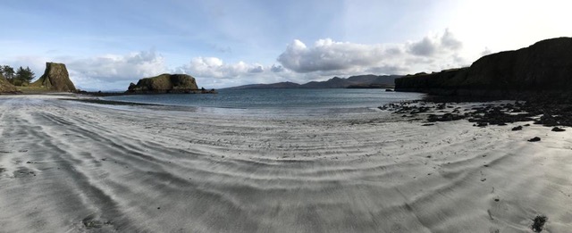 The sandy beach of Coroghan Bay, Canna, with Coroghan Sea Stack and Alman Isle.